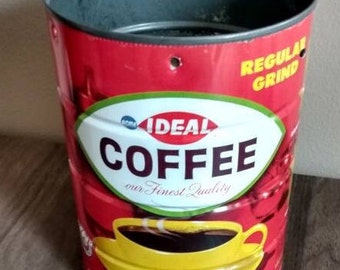 May include: Red and white coffee can with the words "Ideal Coffee our Finest Quality" and "Regular Grind". The can has a picture of a yellow coffee cup with steam coming from it.