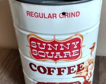 May include: A white metal coffee can with a red and gold label that says "Sunny Square Coffee" and "Regular Grind". The can has a picture of a cup of coffee and a cowboy on it. The can is 32 ounces (2 pounds).