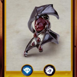 May include: A black ring with a red gemstone and bat wings. The ring is set against a white background. The text "Ring of Vampiric Charm" is below the ring. The text "Requires Attunement" is below the ring. The text "7 000 GP" is below the ring.