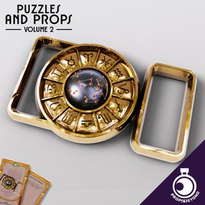 May include: A gold-colored metal belt buckle with a circular design featuring zodiac symbols and a constellation inside a black orb. The buckle is part of a set of puzzles and props.
