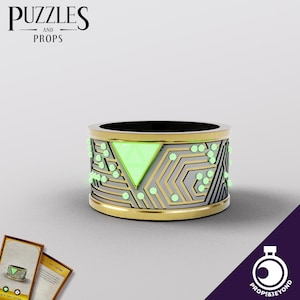 May include: A gold and silver ring with a green glowing triangle in the center. The ring has a circuit board design with small glowing dots.