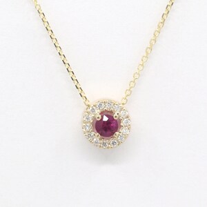 May include: A gold necklace with a ruby pendant surrounded by a halo of diamonds.