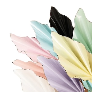 May include: A set of colorful tissue paper sheets with silver edges. The sheets are folded in a fan shape and are arranged in a rainbow pattern.