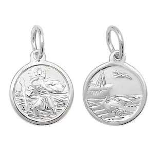 May include: Two silver charm pendants, one with a depiction of Saint Christopher carrying a child, the other with a ship and a small plane flying overhead.