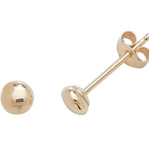 May include: A pair of gold ball stud earrings. The earrings are simple and classic, and they would make a great gift for any occasion.