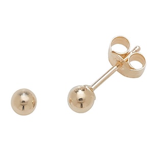 May include: A pair of gold ball stud earrings. The earrings are simple and classic, and they would make a great gift for any occasion.