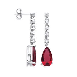 May include: A pair of silver dangle earrings with a red pear-shaped gemstone and a row of clear cubic zirconia stones.