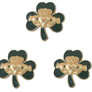 May include: Three gold shamrock charms with a Celtic knot design in the centre. The shamrocks are green with a gold heart and crown.