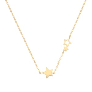 May include: A delicate gold-colored necklace featuring three star pendants. The necklace has a fine chain and a large solid star, a smaller solid star, and a star-shaped cutout. The stars are connected by a delicate chain.