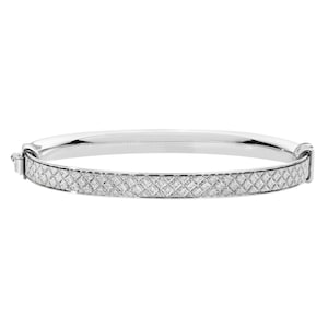 May include: A silver bangle bracelet with a diamond-encrusted band. The band has a geometric pattern.
