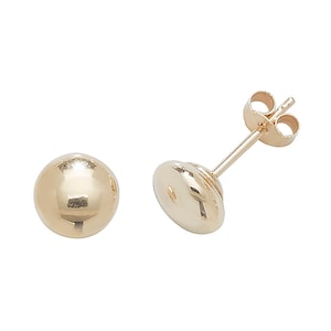 May include: A pair of gold ball stud earrings. The earrings are simple and classic, and they would make a great gift for any occasion.