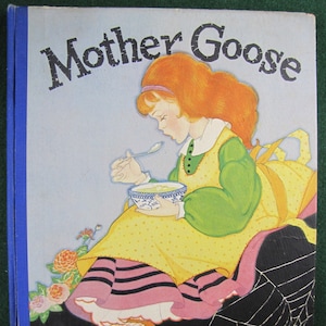 May include: A vintage children's book cover featuring a young girl with red hair sitting on a rock with a spider web behind her. The book title is "Mother Goose" in black lettering.