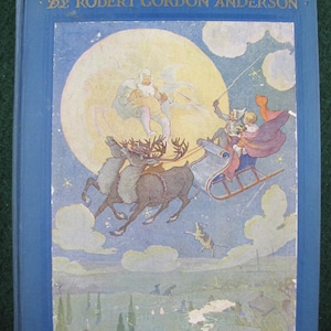 May include: A vintage book titled "Seven O'Clock Stories" by Robert Gordon Anderson. The cover features a whimsical illustration of a sleigh pulled by reindeer, with figures in the sky against a moonlit backdrop. The book has a blue cover.