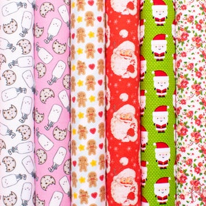 May include: A set of 10 fabric panels featuring various Christmas-themed patterns. The patterns include Santa Claus, gingerbread men, milk bottles, cookies, and floral designs. The fabric is white with red, green, and brown accents.