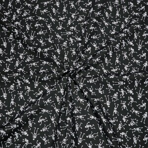 May include: Black fabric with a white skeleton pattern. The skeletons are dancing and are repeated throughout the fabric.