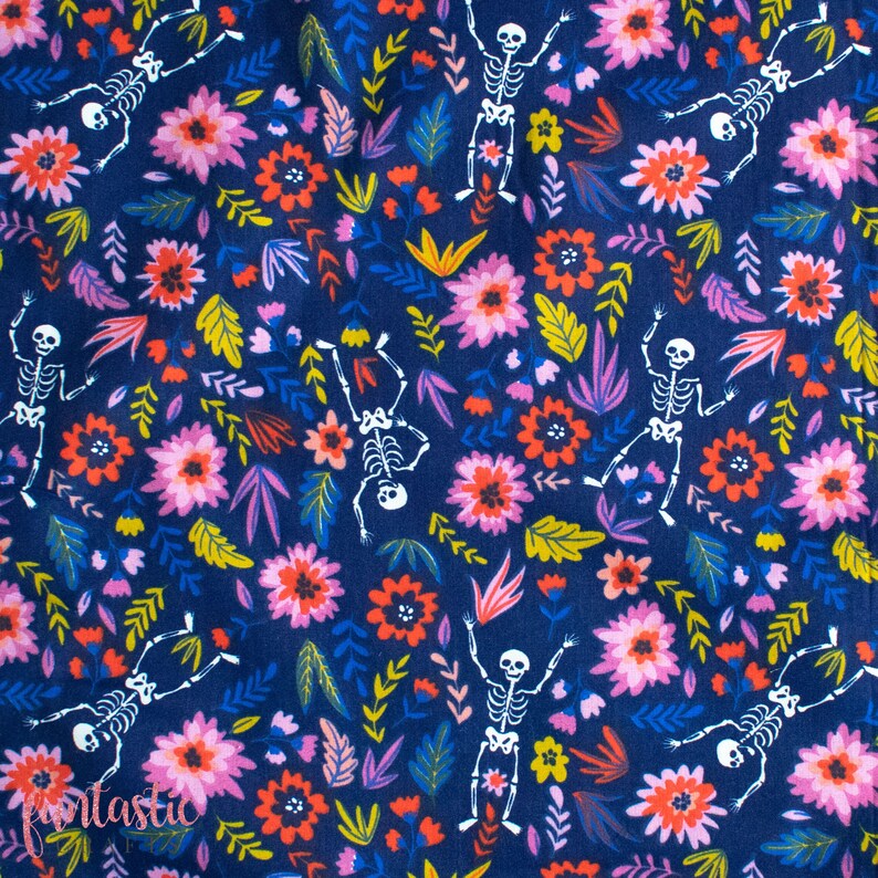 May include: A dark blue fabric with a repeating pattern of white skeletons dancing among pink, red, and yellow flowers. The background is a dark blue color.