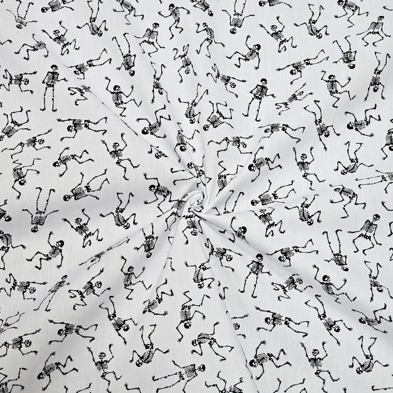 May include: White fabric with a repeating pattern of black skeletons dancing. The skeletons are in various poses and are all facing different directions.