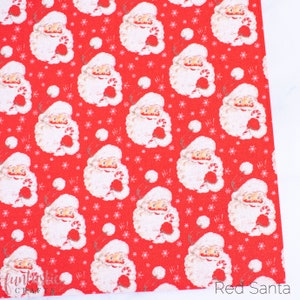 May include: Red fabric with a repeating pattern of a white Santa Claus holding a candy cane. The background is red with white snowflakes. The text "Hi!" appears throughout the fabric.