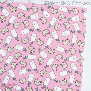 May include: Pink fabric with a repeating pattern of white milk bottles with straws and brown chocolate chip cookies with a bite taken out of them. The text "Pink Milk & Cookies" is in the top right corner of the fabric.