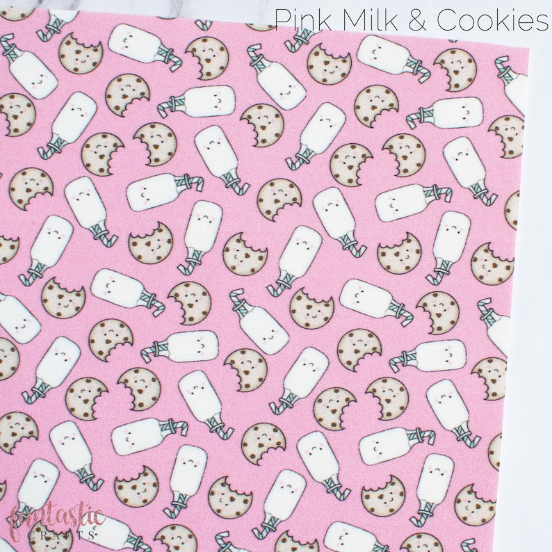 May include: Pink fabric with a repeating pattern of white milk bottles with straws and brown chocolate chip cookies with a bite taken out of them. The text "Pink Milk & Cookies" is in the top right corner of the fabric.