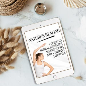 May include: A white tablet computer with a black screen displaying the text "NATURE'S HEALING" and a guide to herbal remedies, whole foods, and a vibrant lifestyle. A woman is shown stretching on the screen.