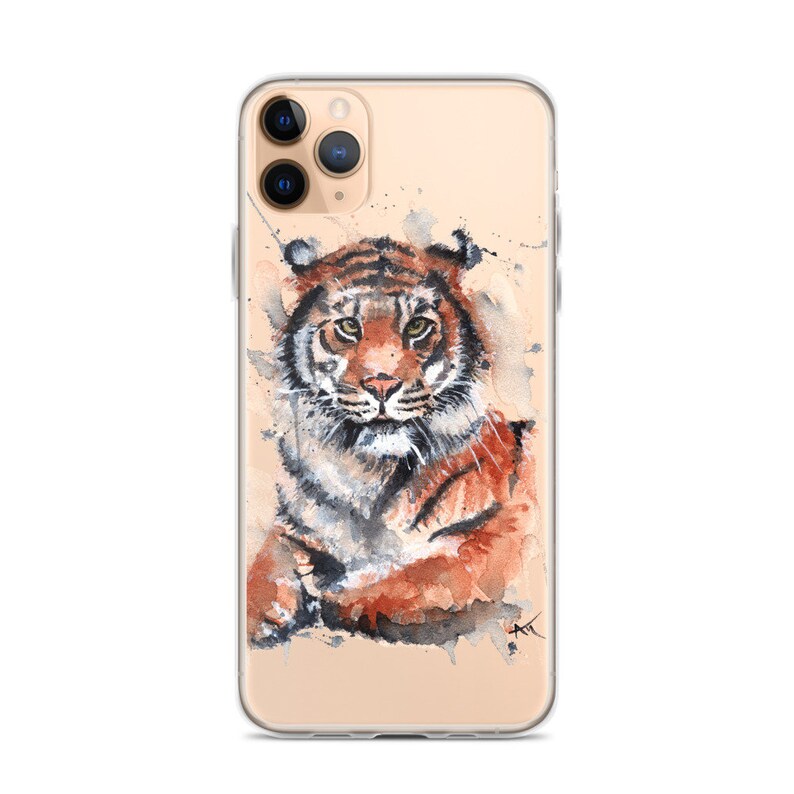 May include: A watercolor painting of a tiger on a clear phone case. The tiger is orange and black with a white background. The phone case is clear and has a gold trim.