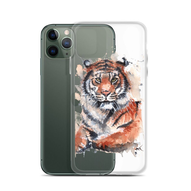May include: A clear phone case with a watercolor painting of a tiger. The tiger is looking directly at the viewer with a serious expression. The background is a light brown with splashes of white and blue.