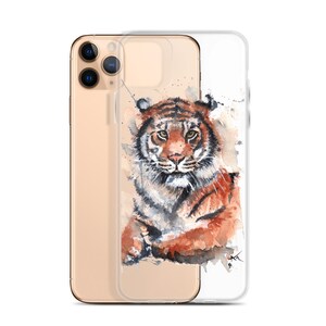May include: A clear phone case with a watercolor illustration of a tiger. The tiger is brown, orange, and black with a white background. The case is designed for an iPhone.