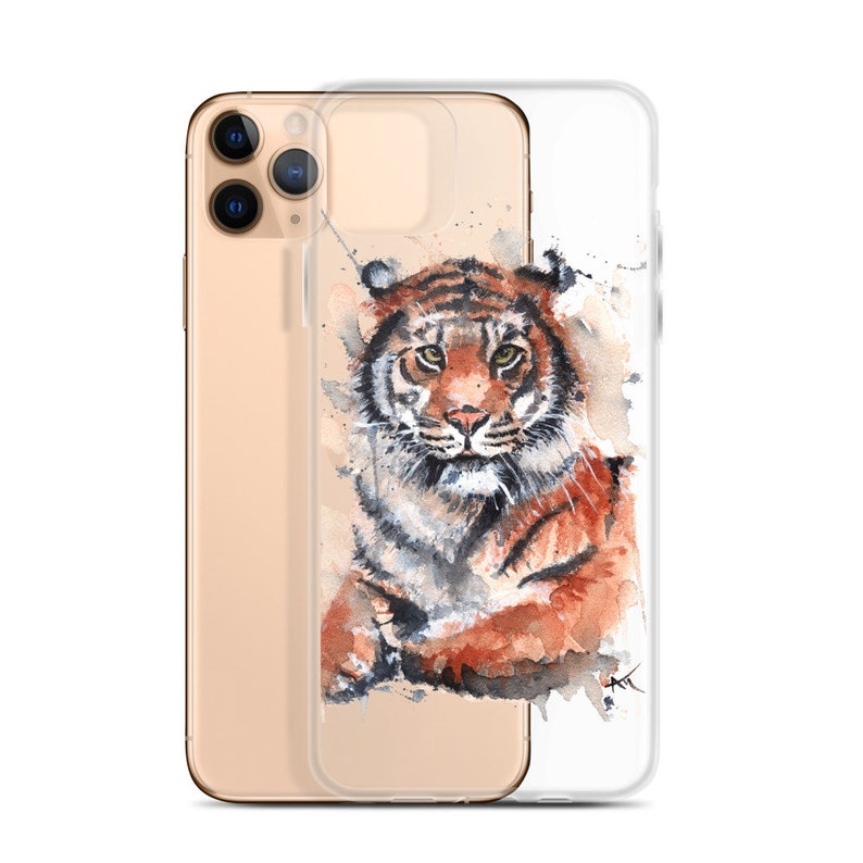 May include: A clear phone case with a watercolor illustration of a tiger. The tiger is brown, orange, and black with a white background. The case is designed for an iPhone.