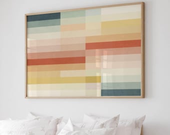 May include: A rectangular wall art piece featuring a grid of horizontal color blocks in shades of teal, cream, yellow, peach, and terracotta, framed in light wood, positioned above a bed with white bedding patterned with small gray stars.