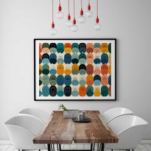 May include: A rectangular wall art print featuring a repeating pattern of nested arch shapes in shades of orange, teal, navy blue, mustard yellow, and light pink on a cream background, enclosed in a thin black frame hanging on a wall.