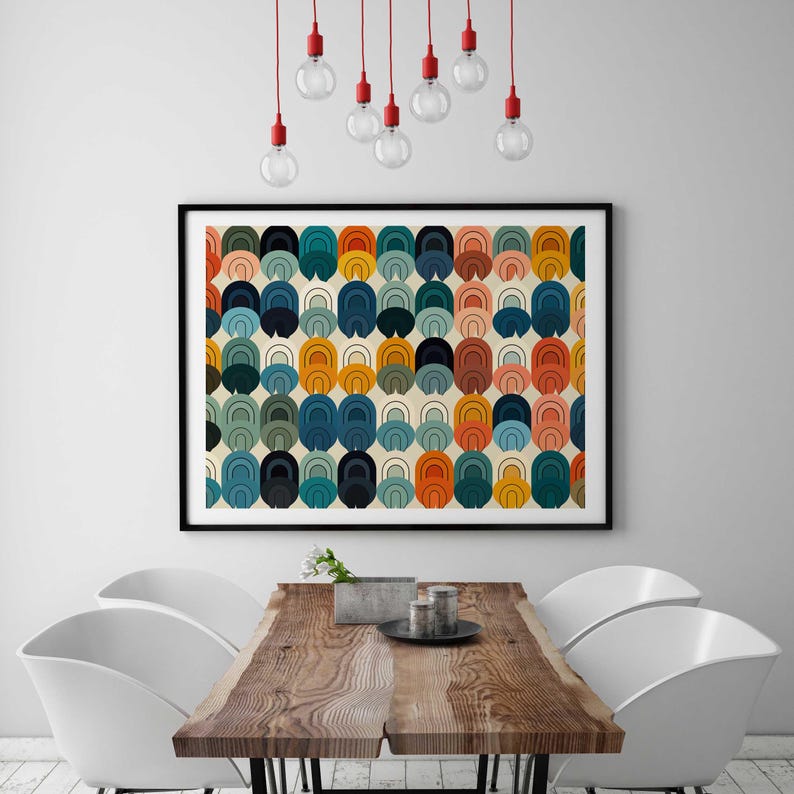 May include: A rectangular wall art print featuring a repeating pattern of nested arch shapes in shades of orange, teal, navy blue, mustard yellow, and light pink on a cream background, enclosed in a thin black frame hanging on a wall.