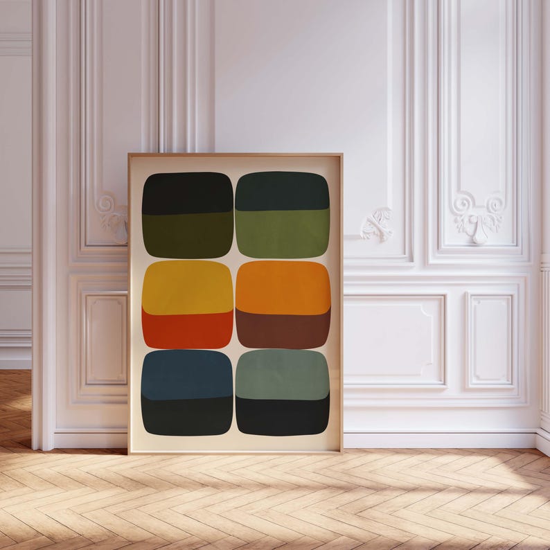 May include: A framed abstract art print featuring six pairs of rounded rectangular shapes in various colors. The color palette includes black, olive green, yellow, orange, red, brown, navy blue, and teal. The artwork is displayed in a room with white walls and a wooden floor.