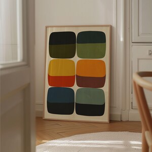 May include: A framed abstract art print featuring six colorful, rounded rectangular shapes. The shapes are divided into two-tone sections of black, green, yellow, orange, and blue, with a neutral background and a wooden frame. The artwork is displayed indoors.