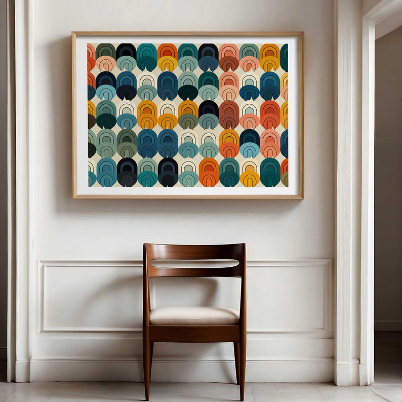 May include: A rectangular wall art print featuring a repeating pattern of stacked, rounded arch shapes in shades of orange, teal, navy blue, and light pink on a cream background, enclosed in a simple light-coloured wooden frame.