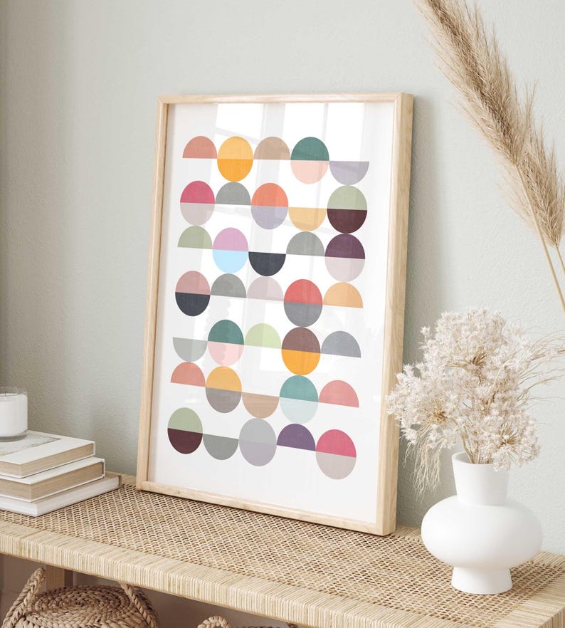 May include: A framed print with a geometric design of colorful circles and semi-circles in shades of red, orange, yellow, green, blue, purple, and gray.