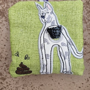 May include: A green fabric pouch with an embroidered image of a dog with a poop bag dispenser attached to its back. The pouch has a brown embroidered poop on the front.
