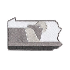 May include: A gray and white embroidered patch in the shape of the state of Pennsylvania. The patch features a stylized design of a mountain range and a sun.