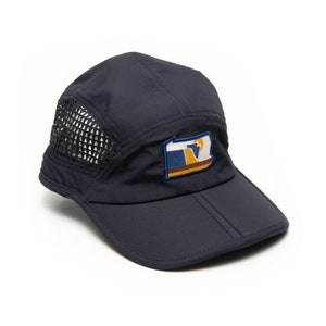 May include: A navy blue mesh and nylon running cap with a patch of the Pennsylvania state flag on the front.