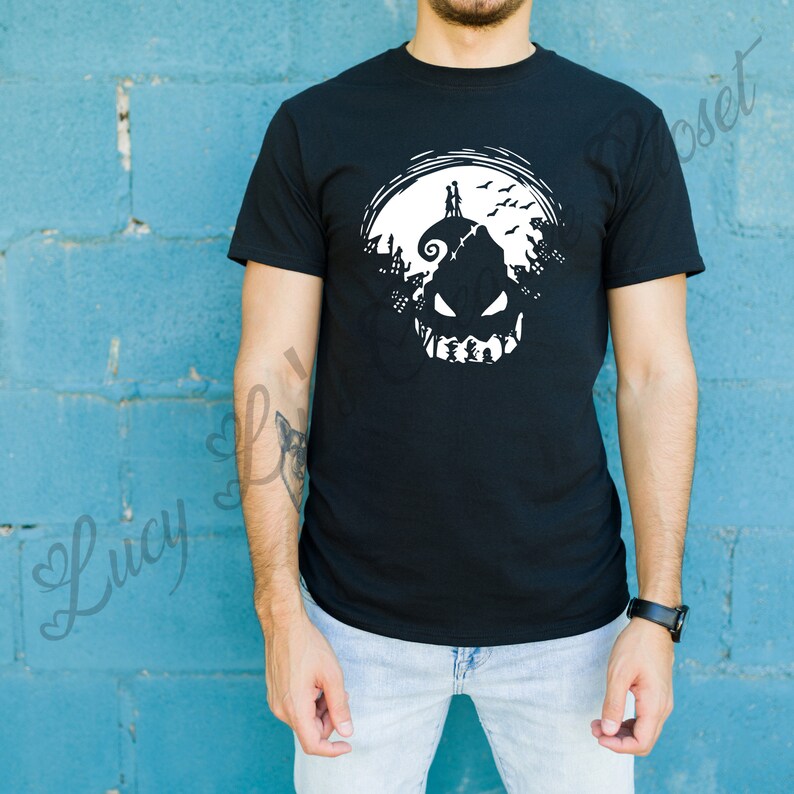 May include: Black t-shirt with a white graphic of a jack-o'-lantern with a silhouette of a couple standing on top of the pumpkin's head.