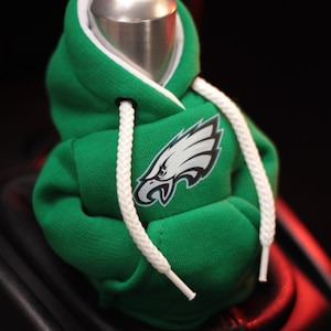 May include: Green and white hooded sweatshirt gear shifter with an embroidered Philadelphia Eagles logo.