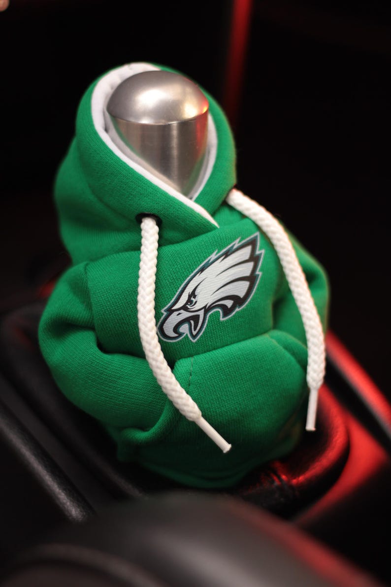 May include: Green and white hooded sweatshirt gear shifter with an embroidered Philadelphia Eagles logo.