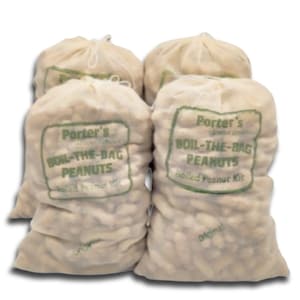 May include: Four white mesh bags filled with peanuts. Each bag has a green label that reads "Porter's Boil-The-Bag Peanuts Boiled Peanut Kit".