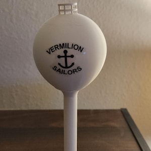 May include: A white 3D printed model of a water tower with the text "VERMILION SAILORS" and an anchor symbol.