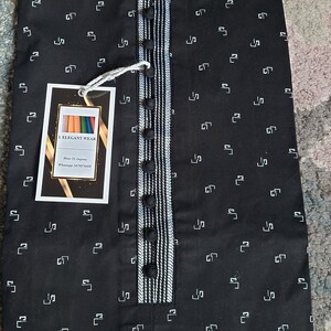 May include: Black kurta with a white geometric pattern. The collar and placket feature white and black striped detailing. The shirt has a button-down front and a tag that reads "I. ELEGANT WEAR".