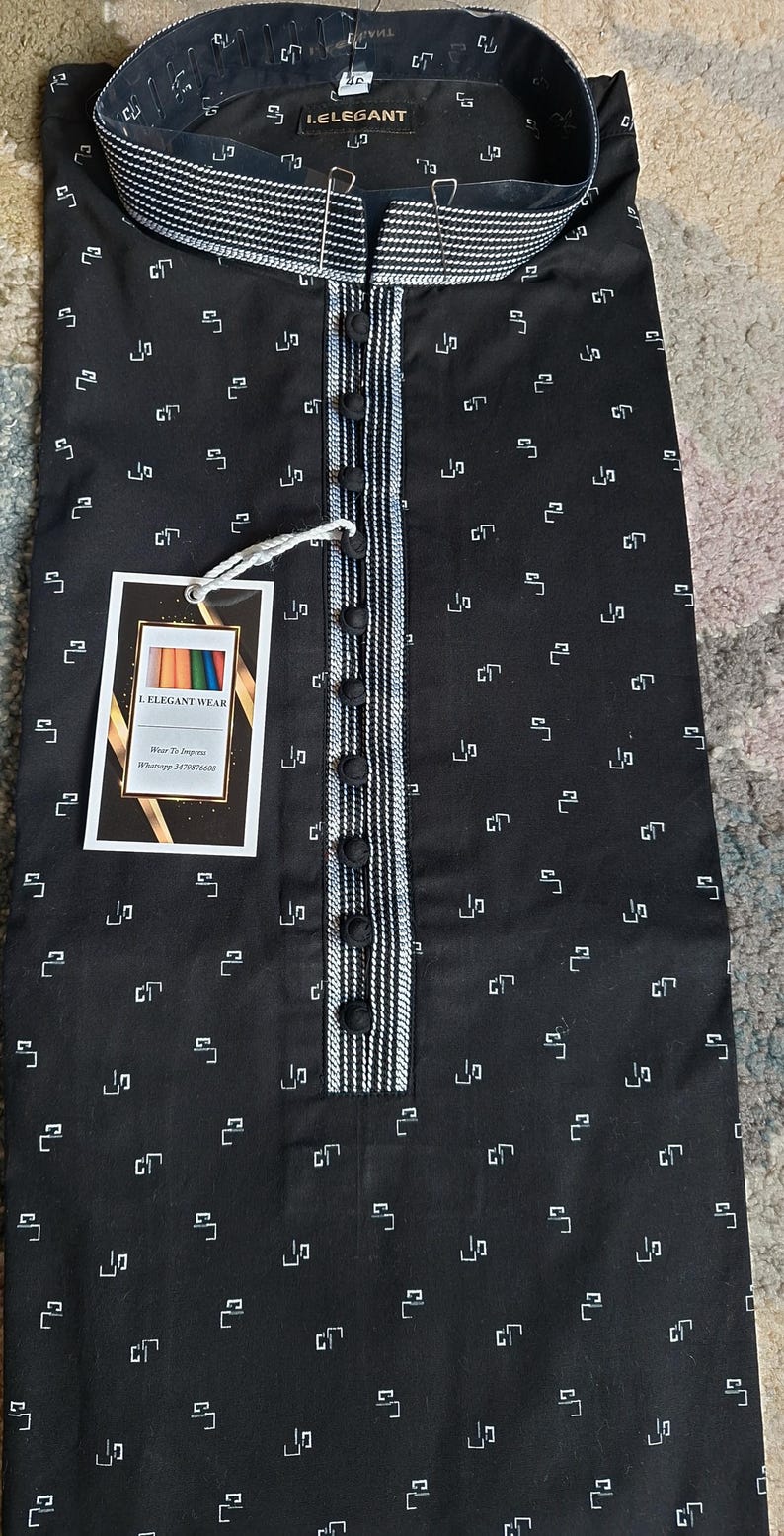May include: Black kurta with a white geometric pattern. The collar and placket feature white and black striped detailing. The shirt has a button-down front and a tag that reads "I. ELEGANT WEAR".