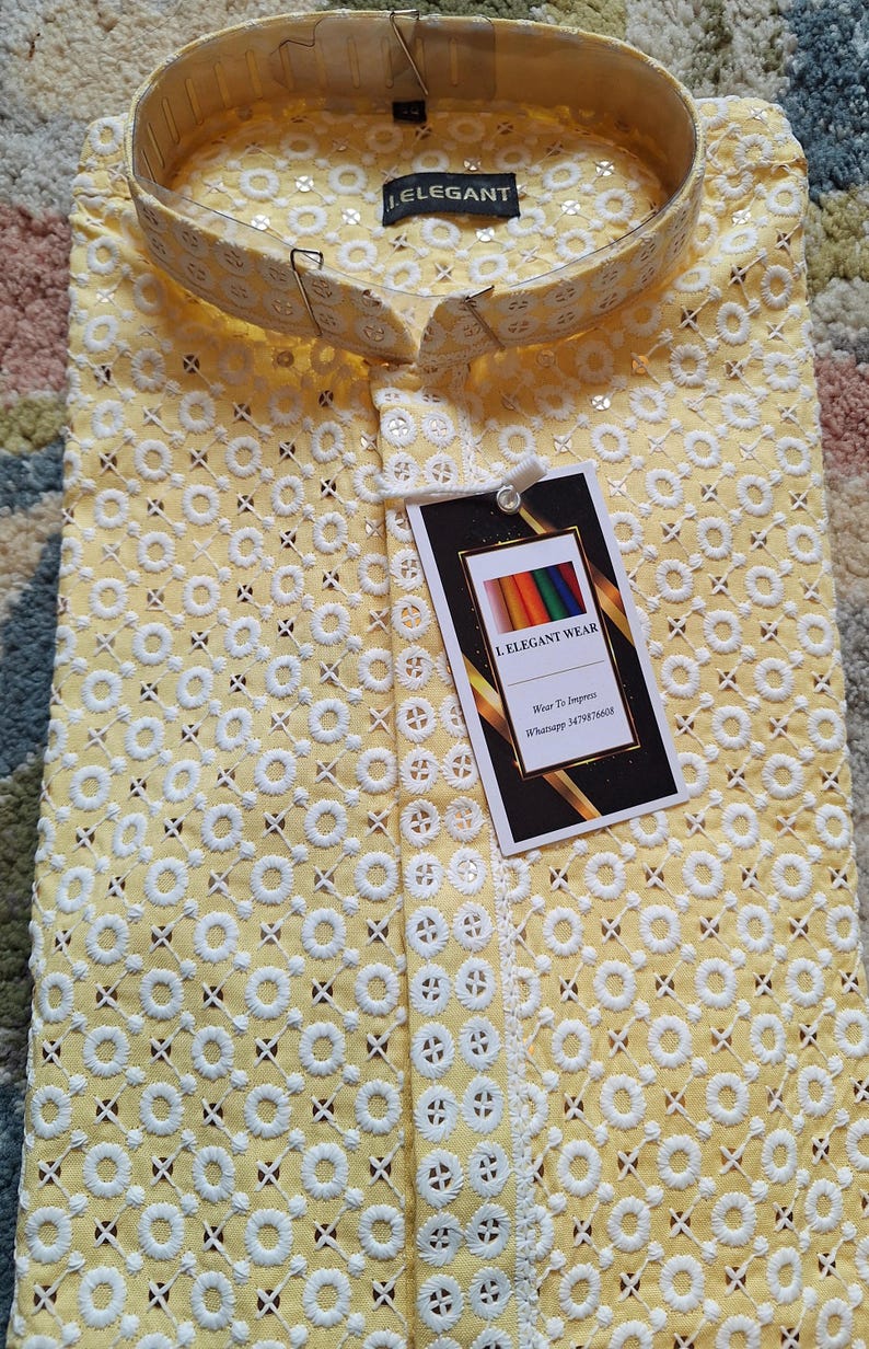 May include: A yellow embroidered shirt with a white collar and a white tag that says "I Elegant Wear" with the text "Wear To Impress" and a WhatsApp number.