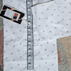 May include: White kurta with a geometric pattern and a mandarin collar. The kurta features a button-down front with decorative trim and a tag that reads "I.ELEGANT WEAR".
