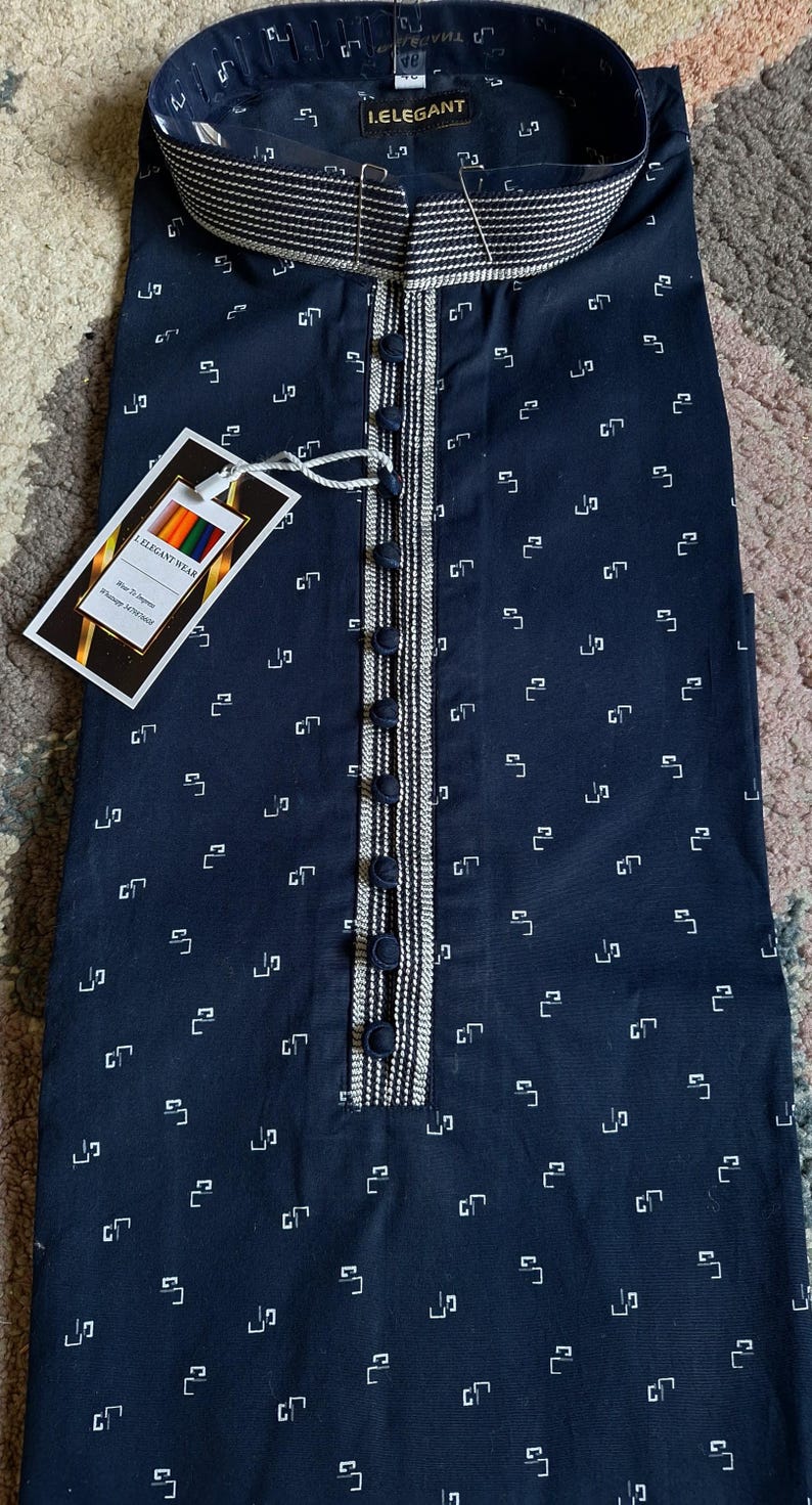 May include: Navy blue kurta with a white geometric pattern. The kurta features a mandarin collar, a button-down placket with decorative trim, and a tag that reads "I.ELEGANT WEAR".