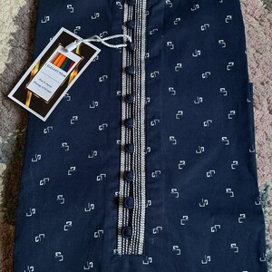 May include: Navy blue kurta with a white geometric pattern. The kurta features a mandarin collar, a button-down placket with decorative trim, and a tag that reads "I.ELEGANT WEAR".